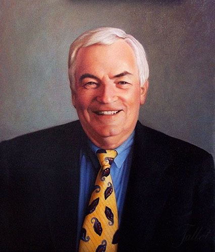 A photograph of an oil painting depicting a smiling older man with white hair and bright yellow Paisley tie